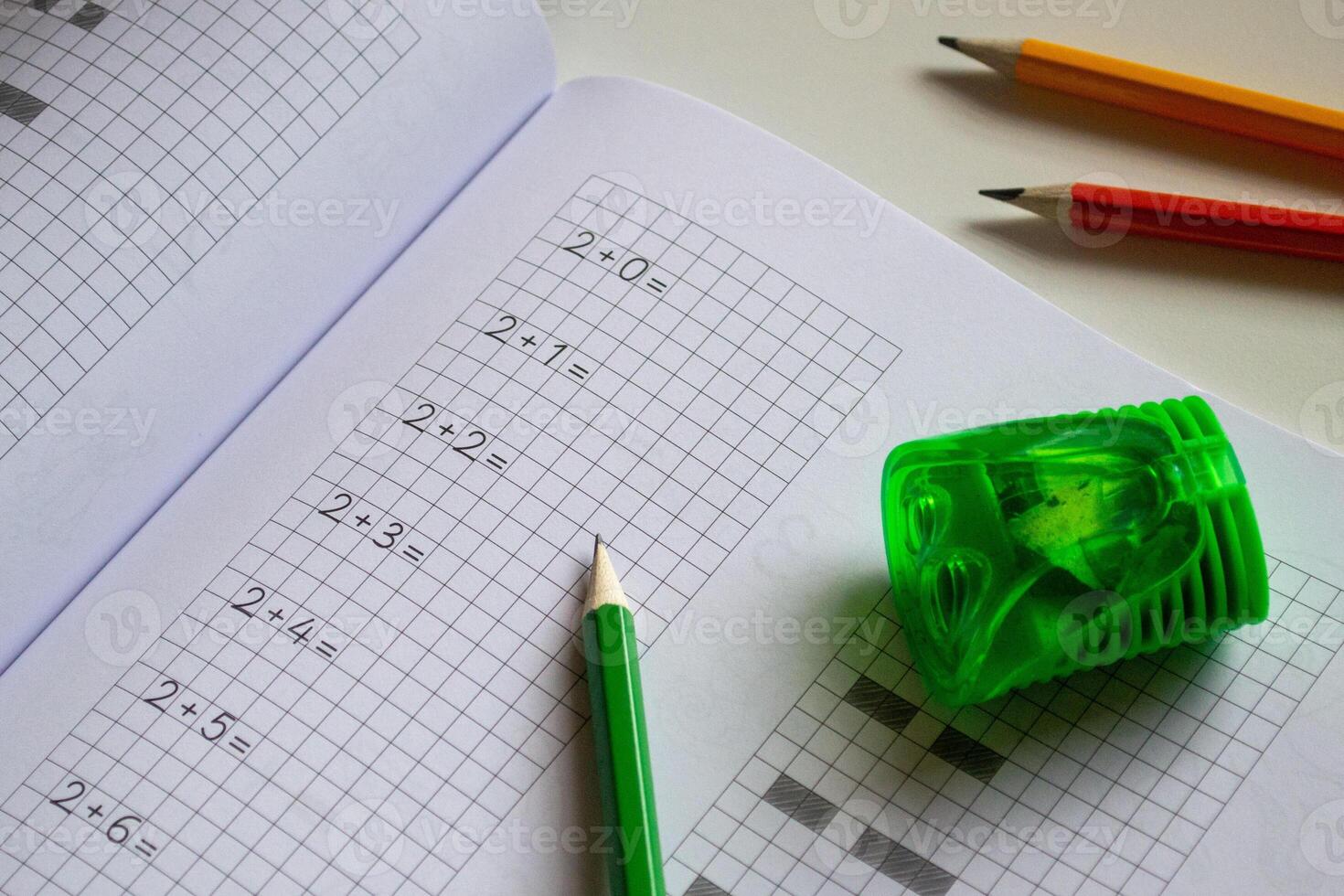 View of notebook and pencils, back to school, learning to write letters correctly photo