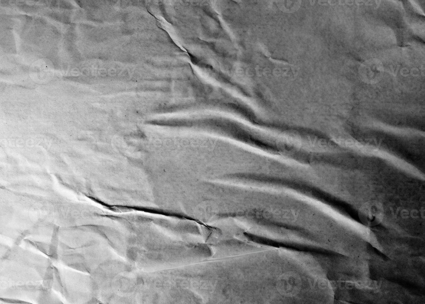 Grayscale wrinkled paper texture with folds and subtle creases, ideal for abstract and design projects. photo