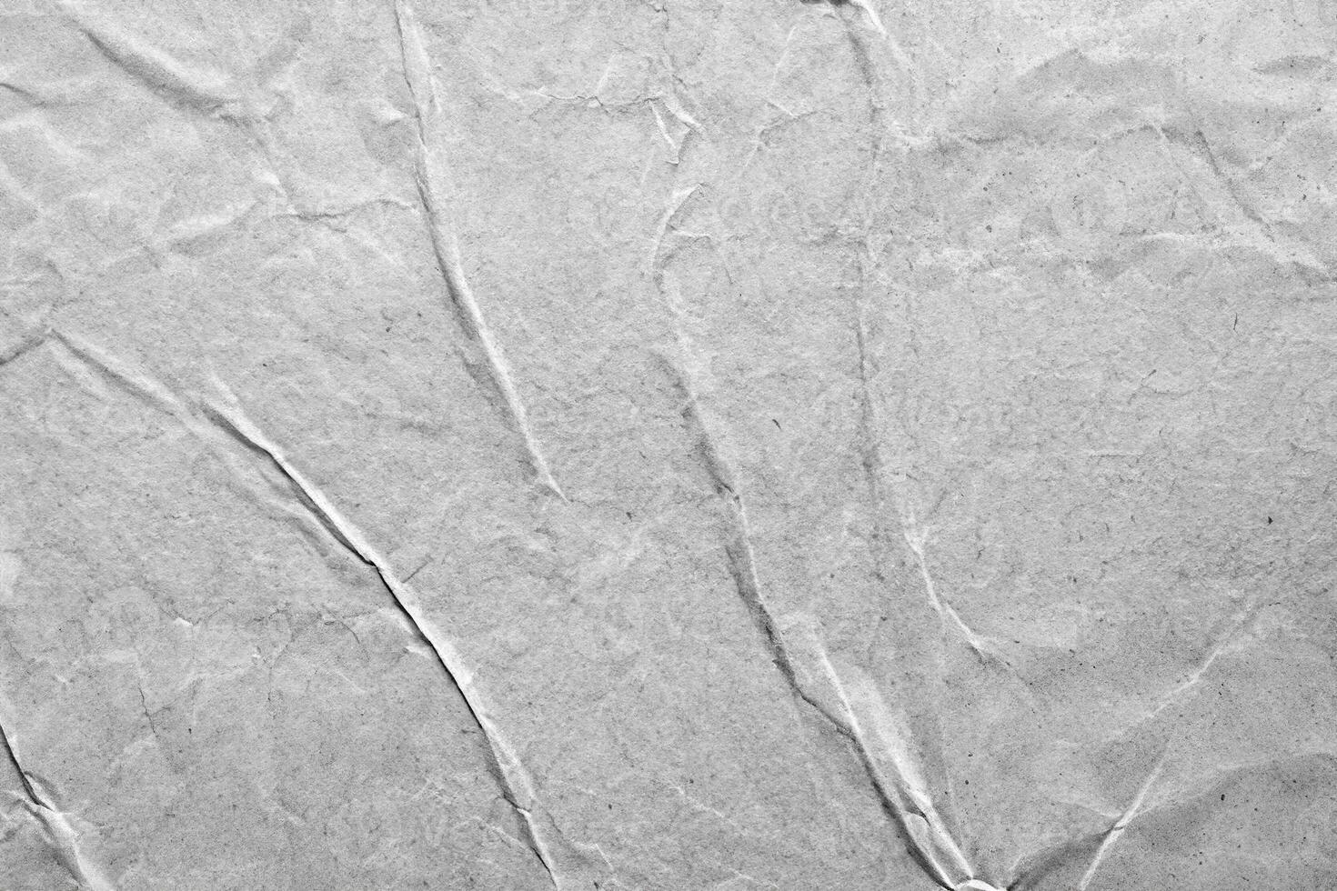 Gray wrinkled paper texture with subtle folds and creases, ideal for design projects or artistic overlays. photo