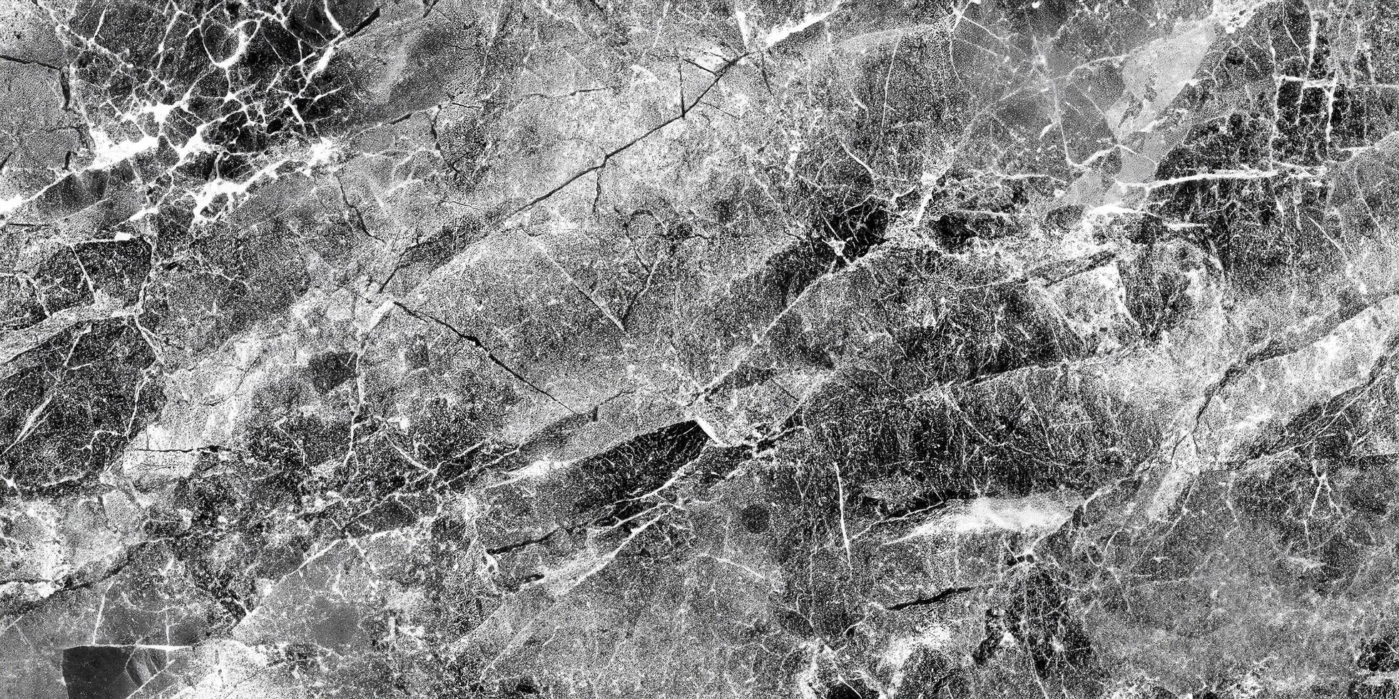 High-contrast black and white marble texture with intricate cracks, perfect for backgrounds or design overlays. photo