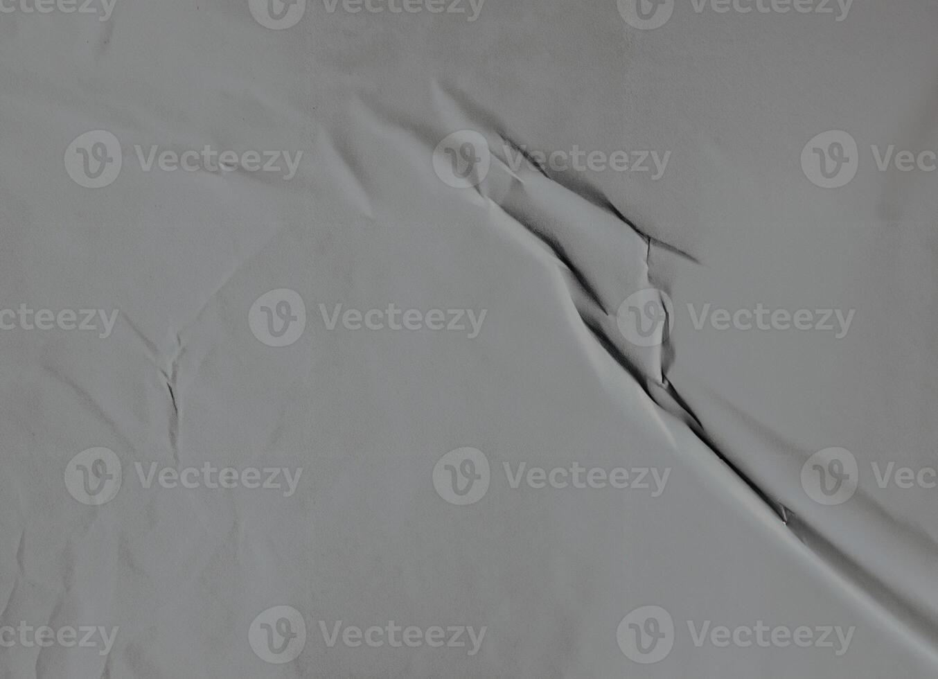 Minimalistic gray wrinkled paper texture with soft folds and subtle surface details. photo
