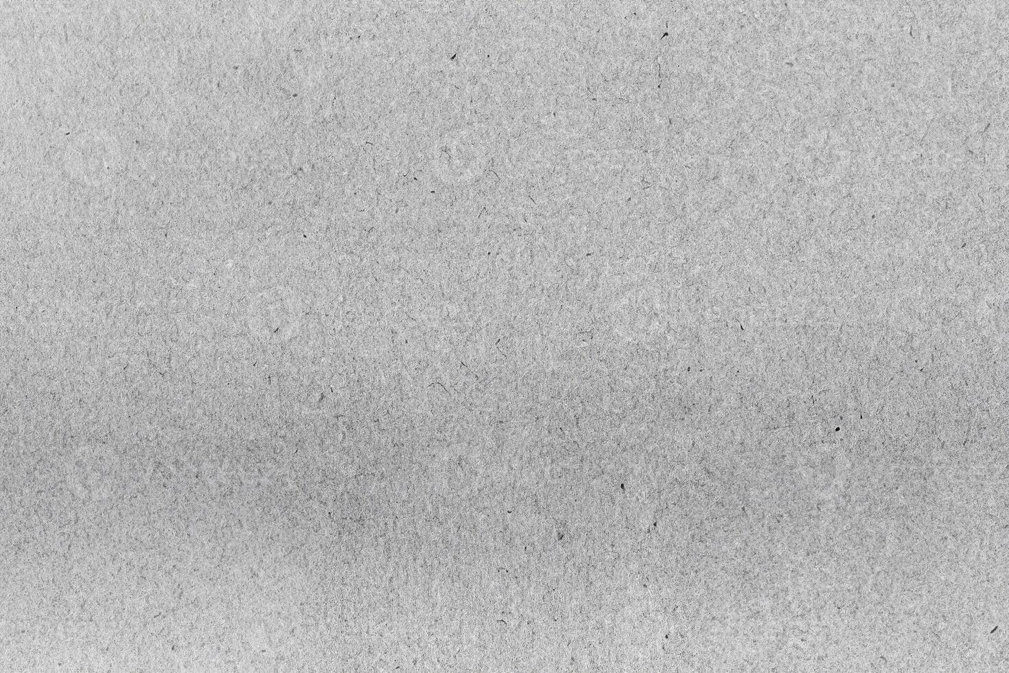 Close-up of a gray recycled paper texture with subtle fibers and organic patterns, perfect for design or backgrounds. photo