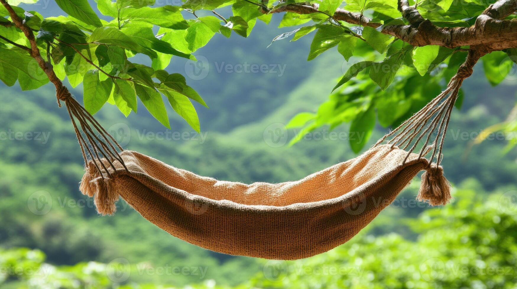 A cozy hammock hangs between trees, inviting relaxation in a peaceful and green environment photo
