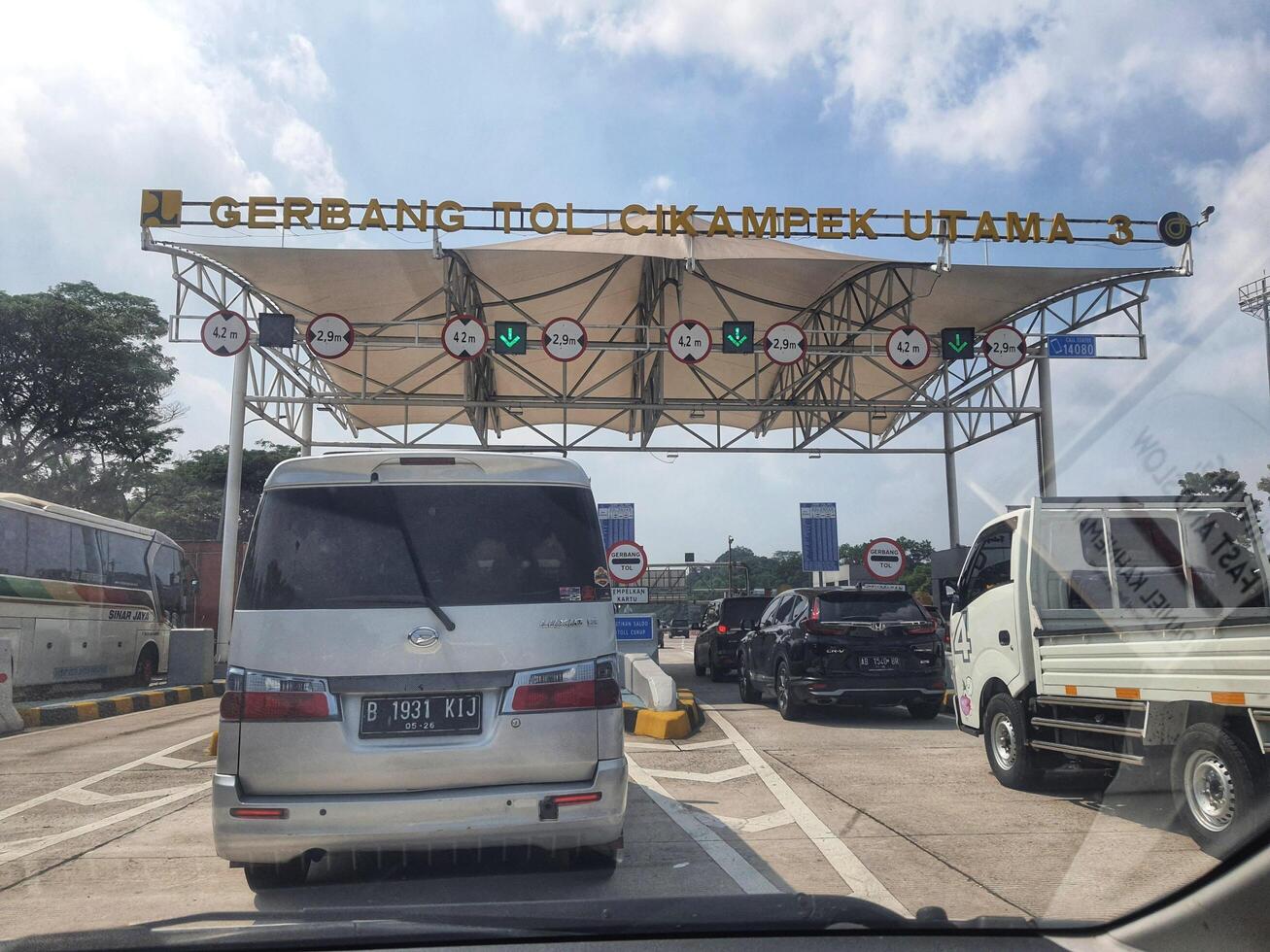Cikampek, Indonesia on 17 April 2024. Cikampek Utama 3 Toll Gate Vehicles Under Canopy Daylight photo