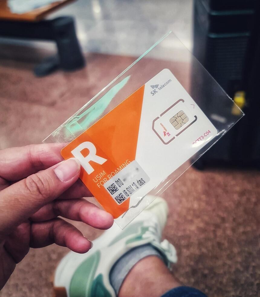 Seoul, South Korea on 6 Nov 2024. SK Telecom Roaming USIM Card A Simple, Orange-Accented Travel Essential photo