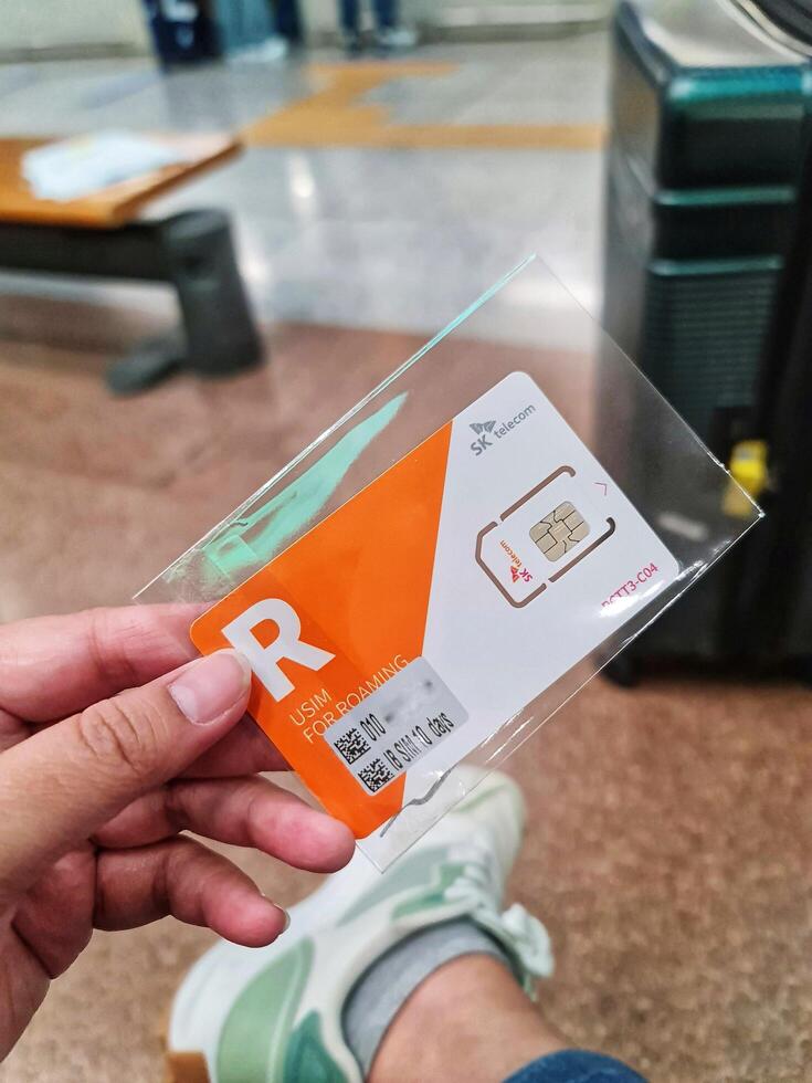 Seoul, South Korea on 6 Nov 2024. SK Telecom Roaming USIM Card A Close-Up, Candid Shot photo