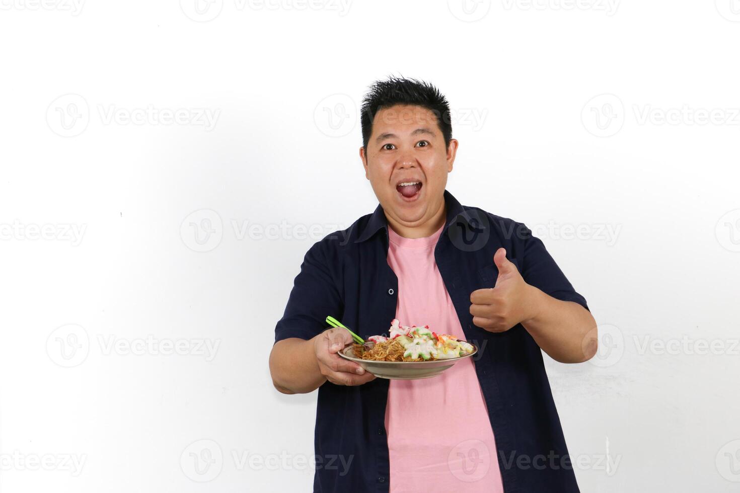 Man enjoying a delicious meal and thumbs up over isolated white background photo