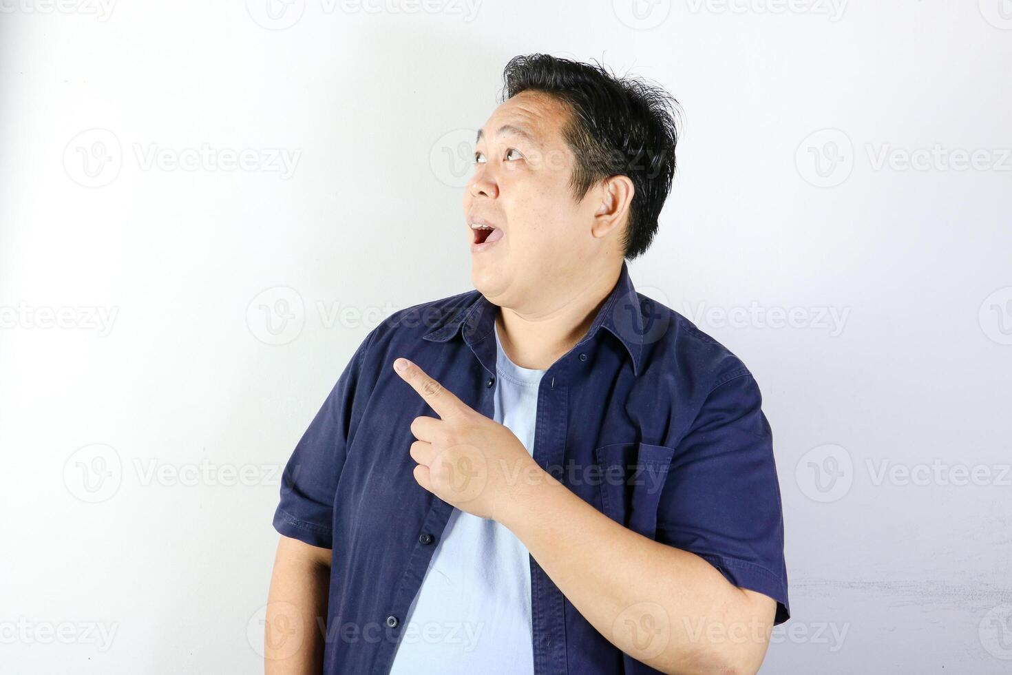 Cheerful Man Pointing his finger into cope space on his right side photo