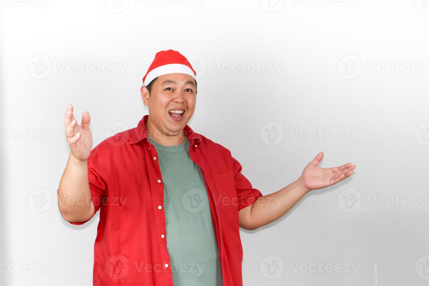 Happy Man in Santa Hat with open hand gesture photo
