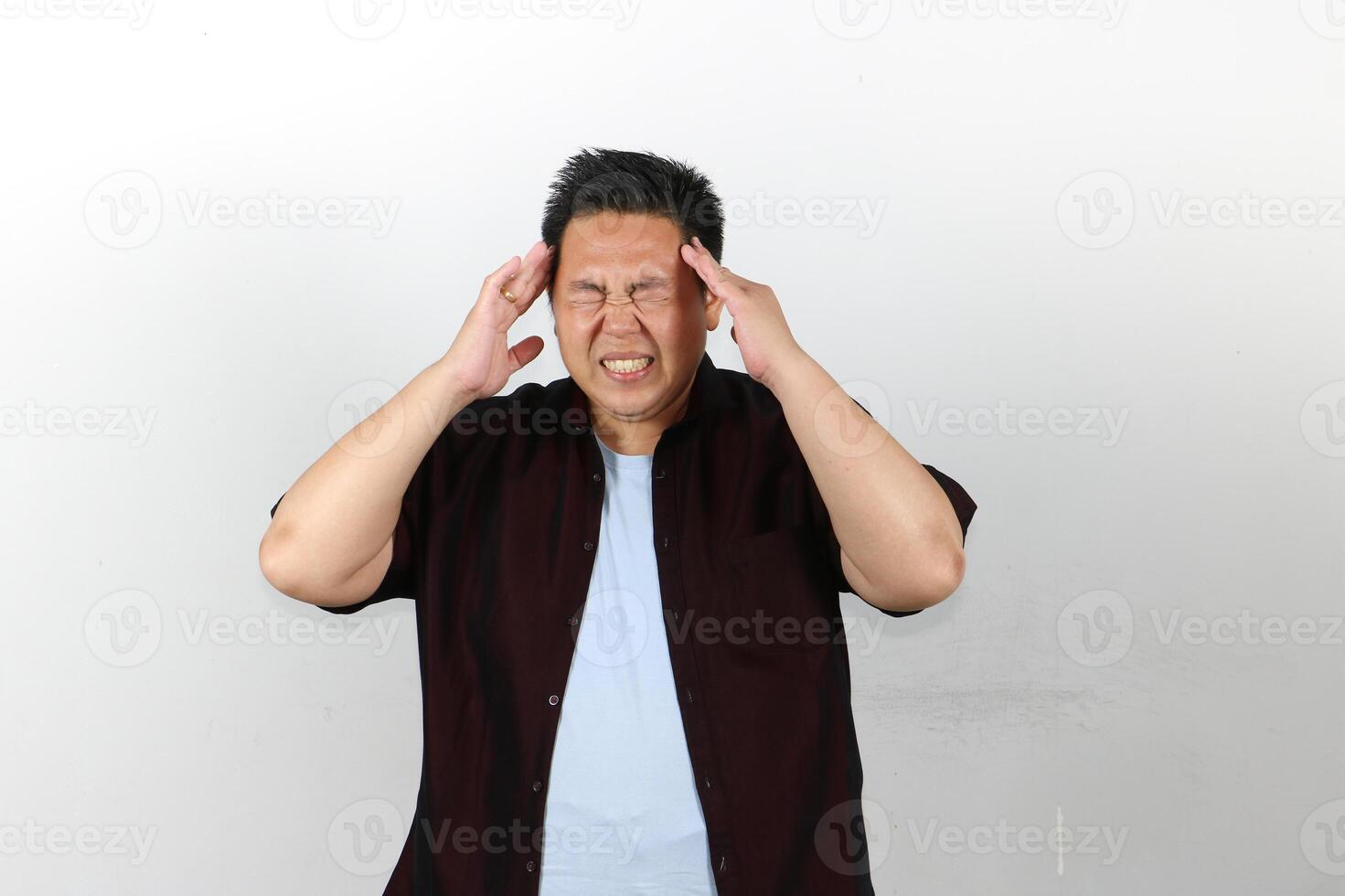 Man Suffering from very bad Headache, both hands on his head photo