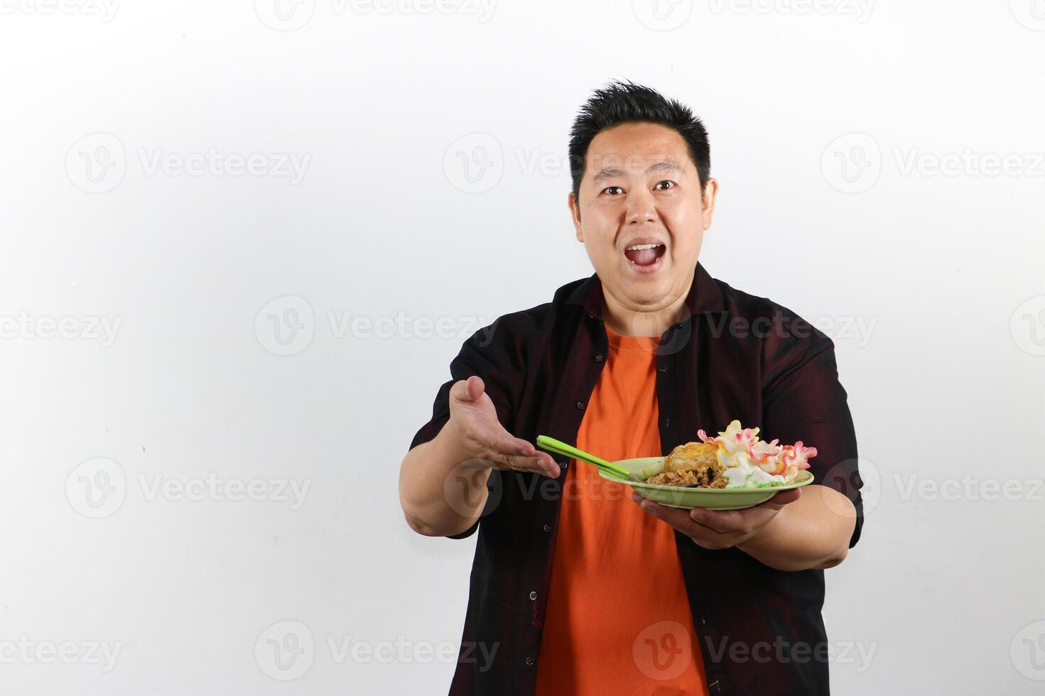 Handsome smiling Man serving a plate of Indonesian Fried Noodle photo