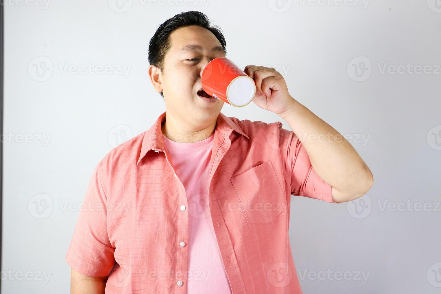 Man Enjoying a Drink from a red cup photo