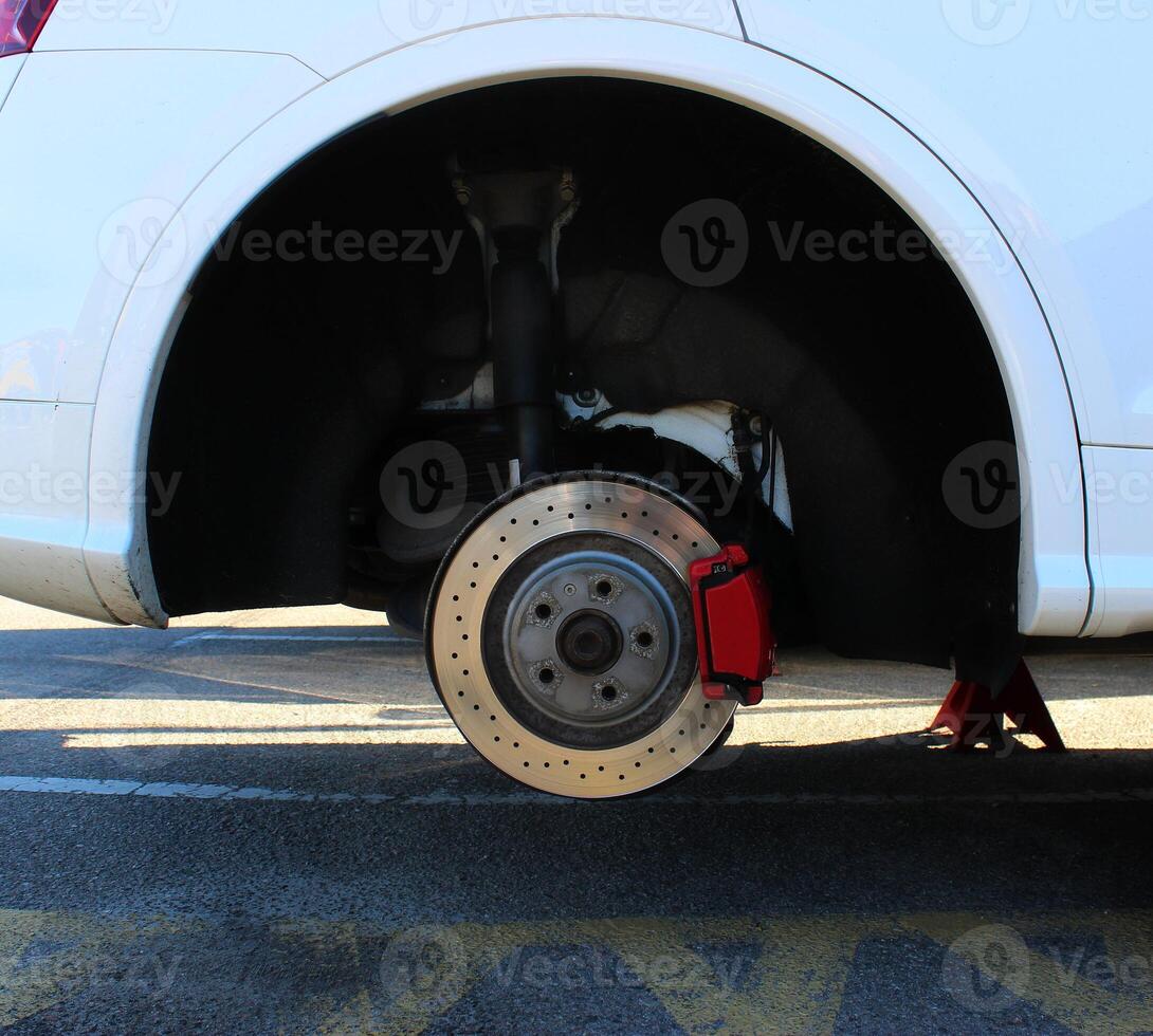 The wheel arch with the wheel removed provides access to check the brake system and shock absorber of the car. Vehicle diagnostic and wheel inspection stock image photo