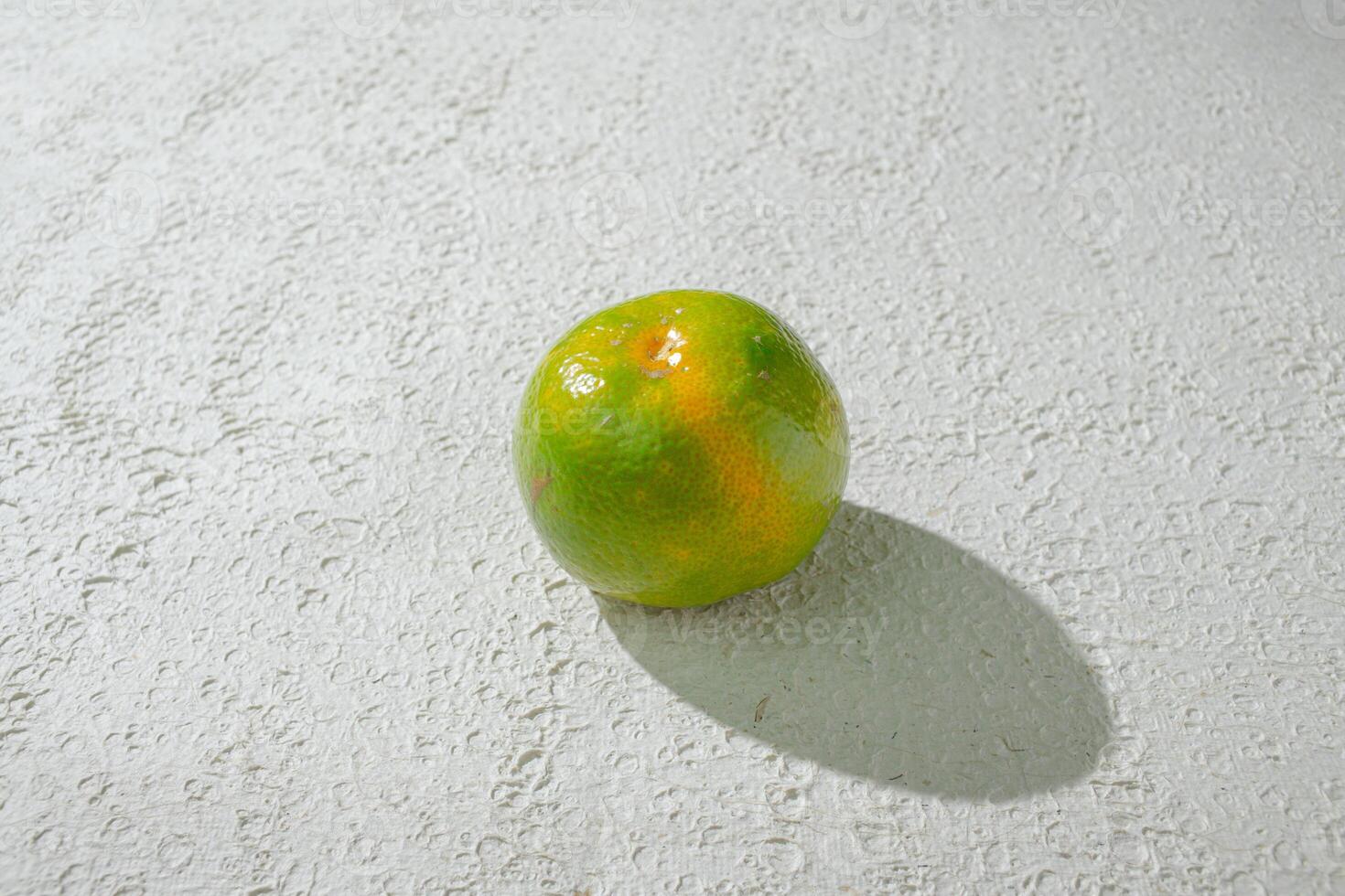 a single green orange isolated on white texture background photo