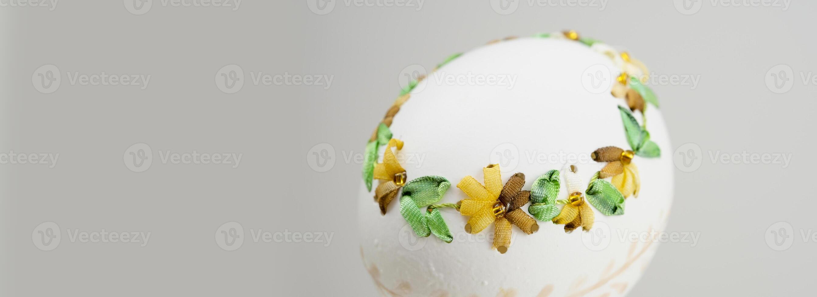 Composition with Easter eggs and green branches on beige background photo