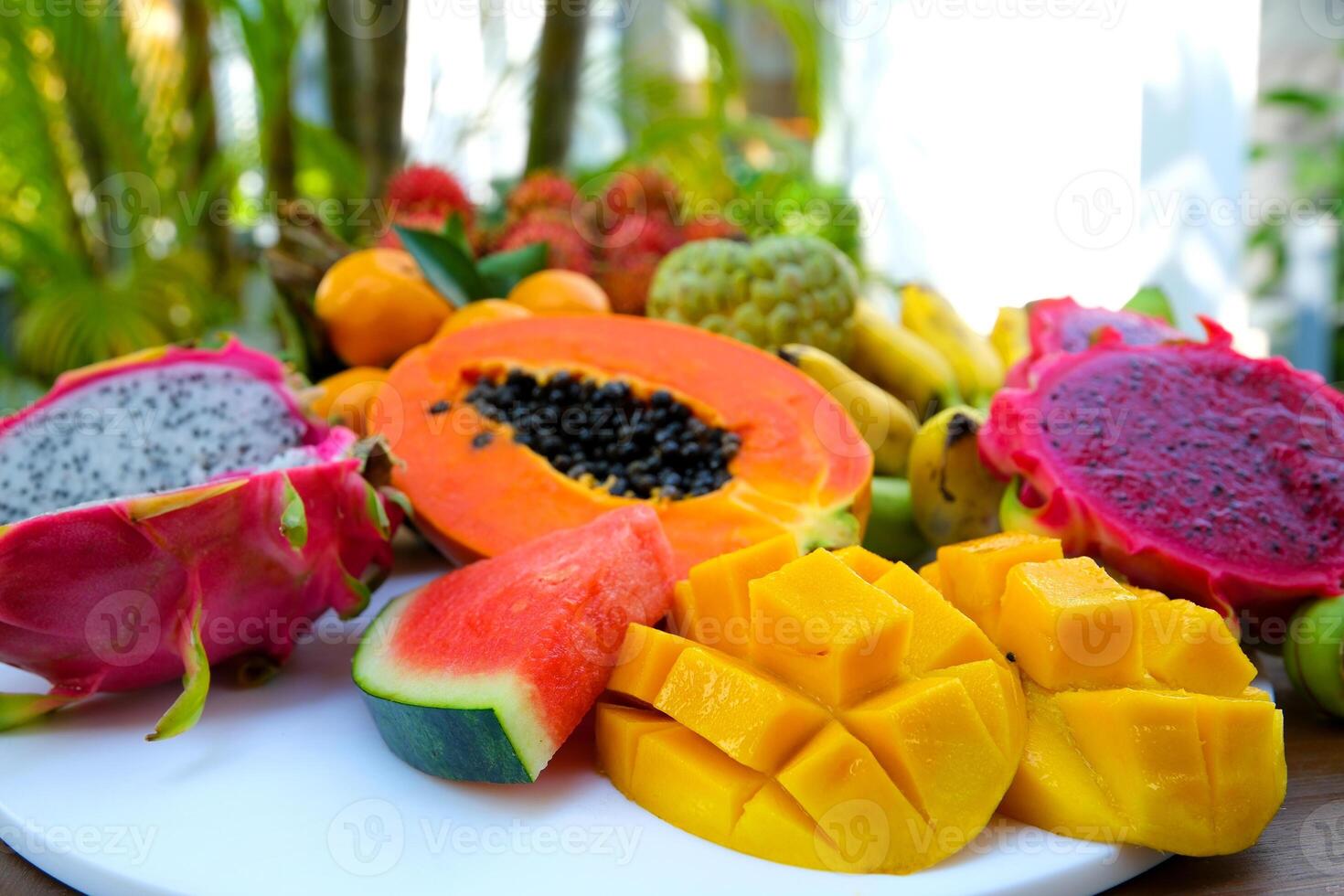 Thai Fresh Exotic Fruits , Pineapple, Coconut, Mango, Rambutan, Masngosteen, Dragon Fruit, Rose Apple, Sugar Apple, Snake Fruit on the Table. Healthy Vitamin Nutritious Food. Thailand. photo