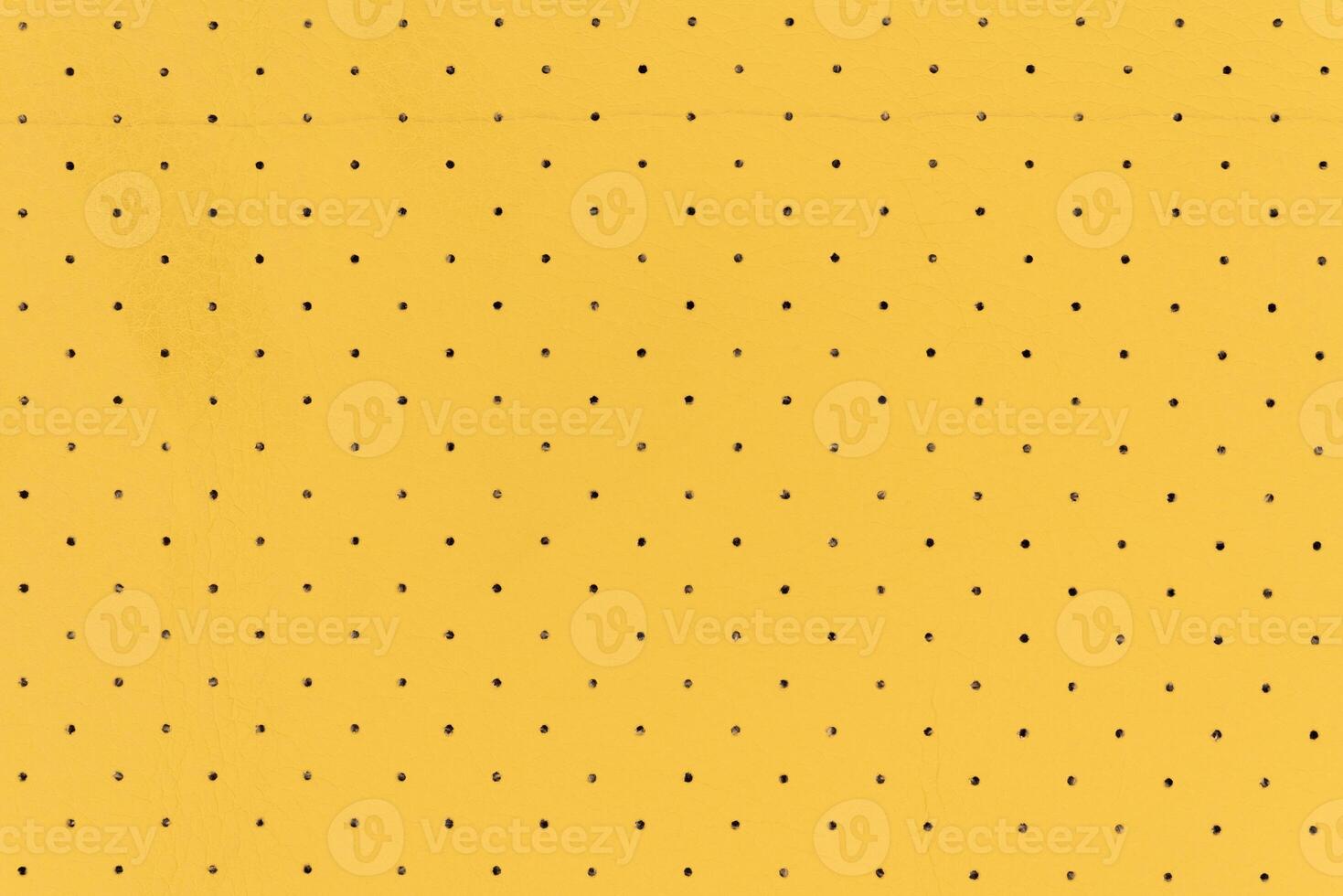 Yellow color abstract artificial leather with dots and holes pattern for background photo