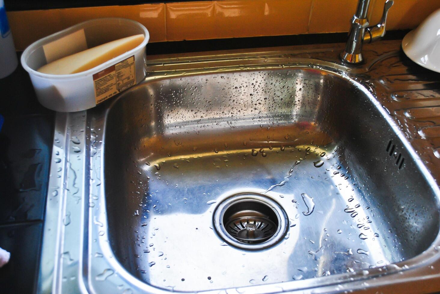 Modern stainless steel tap in new kitchen photo