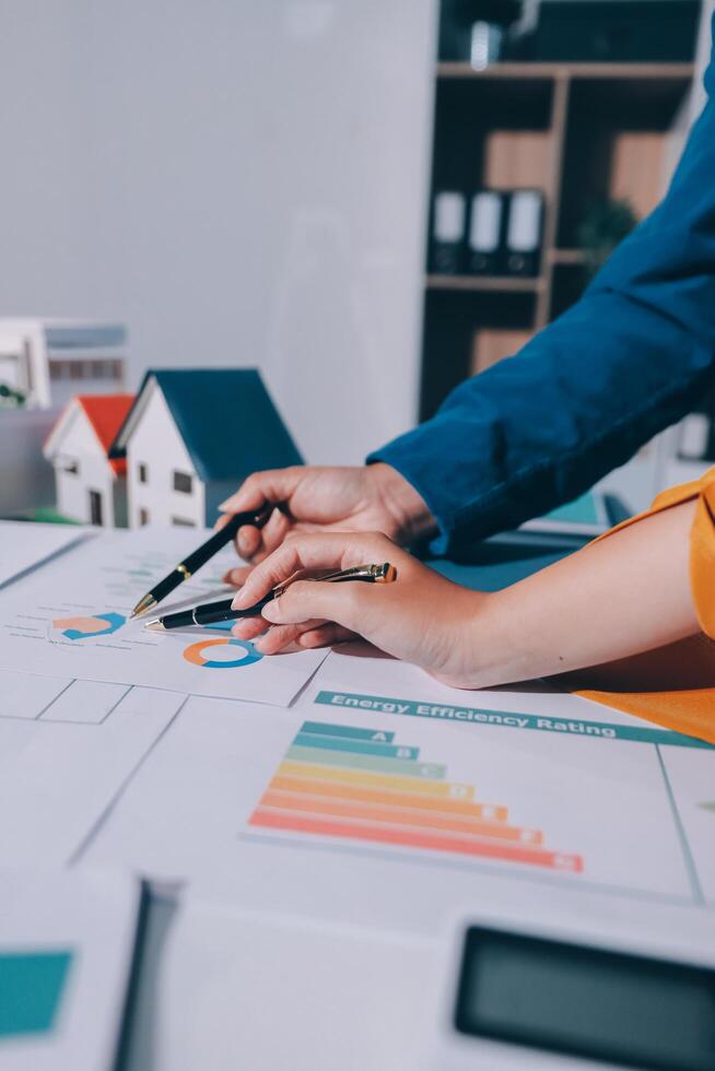 Businessman's hands on desk with graphs and papers photo