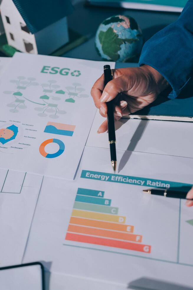 A person is writing on a paper with the words esg and energy efficiency photo