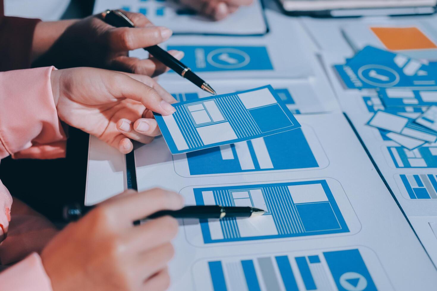A group of people working on a project with blue and white paper photo