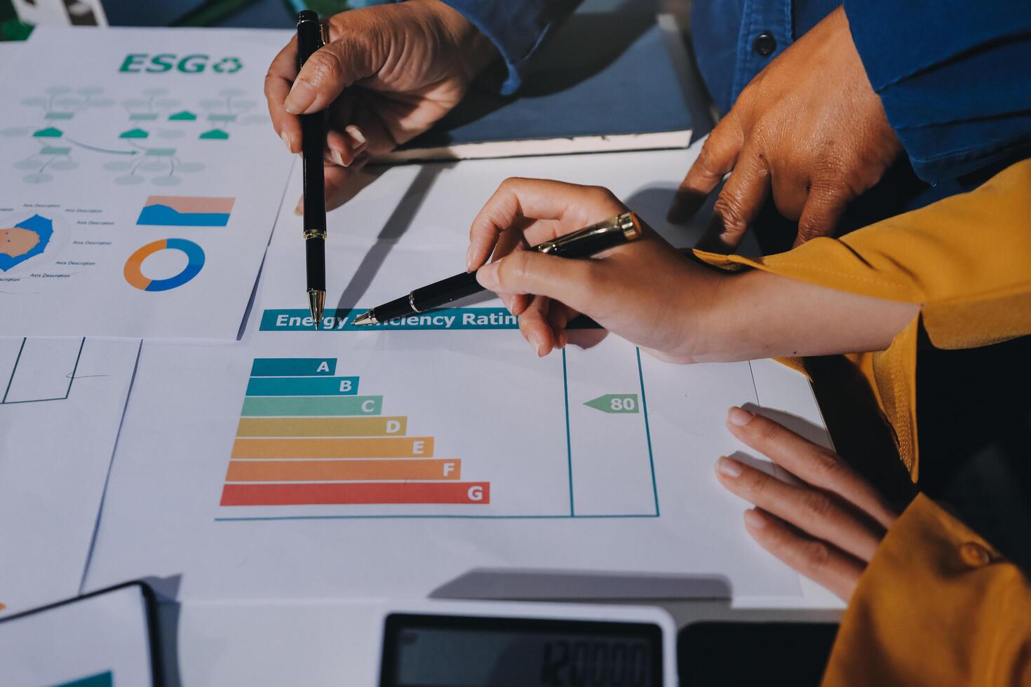 Business people working on a project with graphs and papers photo