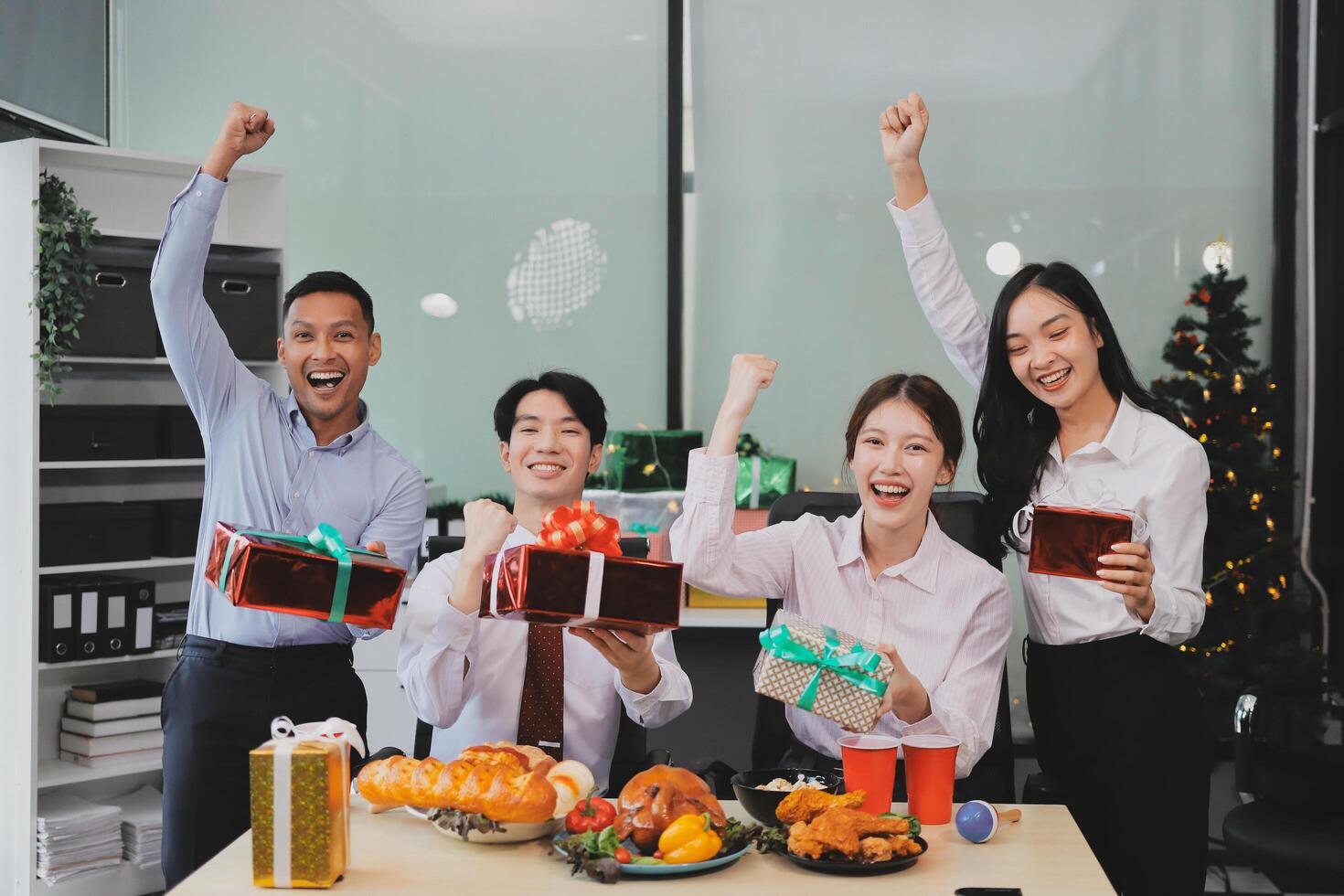 Asian business people celebrating christmas with gifts photo