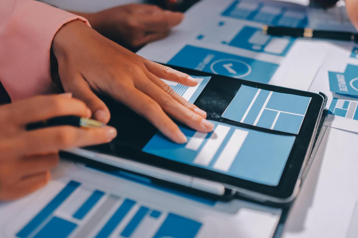 A person is using a tablet with blue and white icons photo