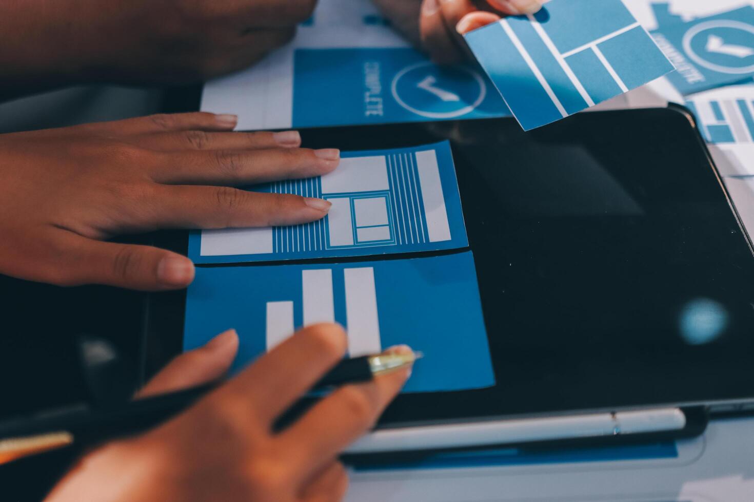 A person is using a tablet to make a design photo