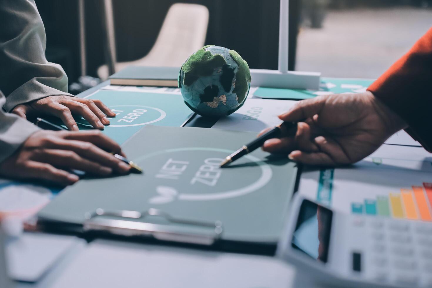 Business people working on a project with a globe photo