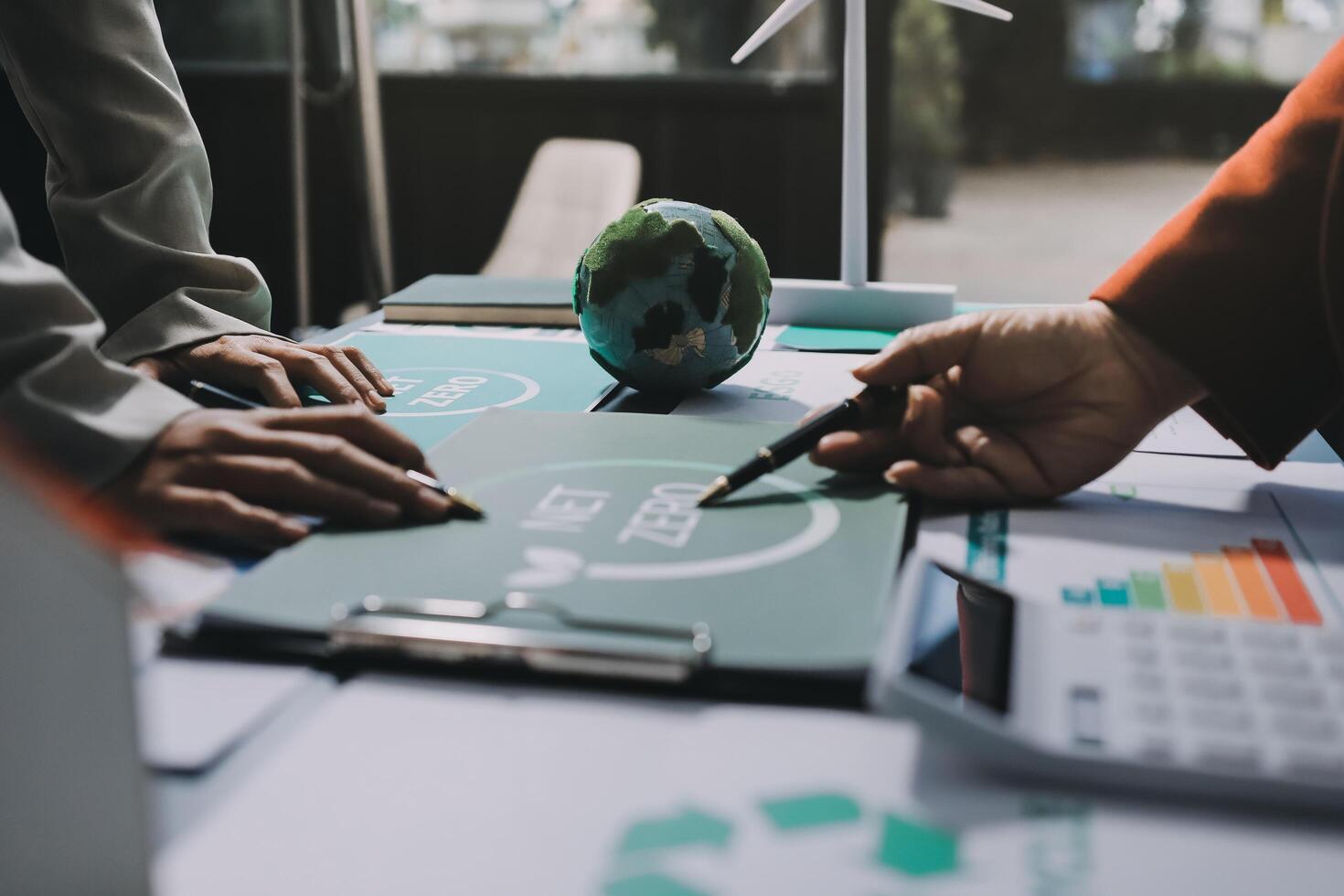 Business people working on a project with eco-friendly logo photo