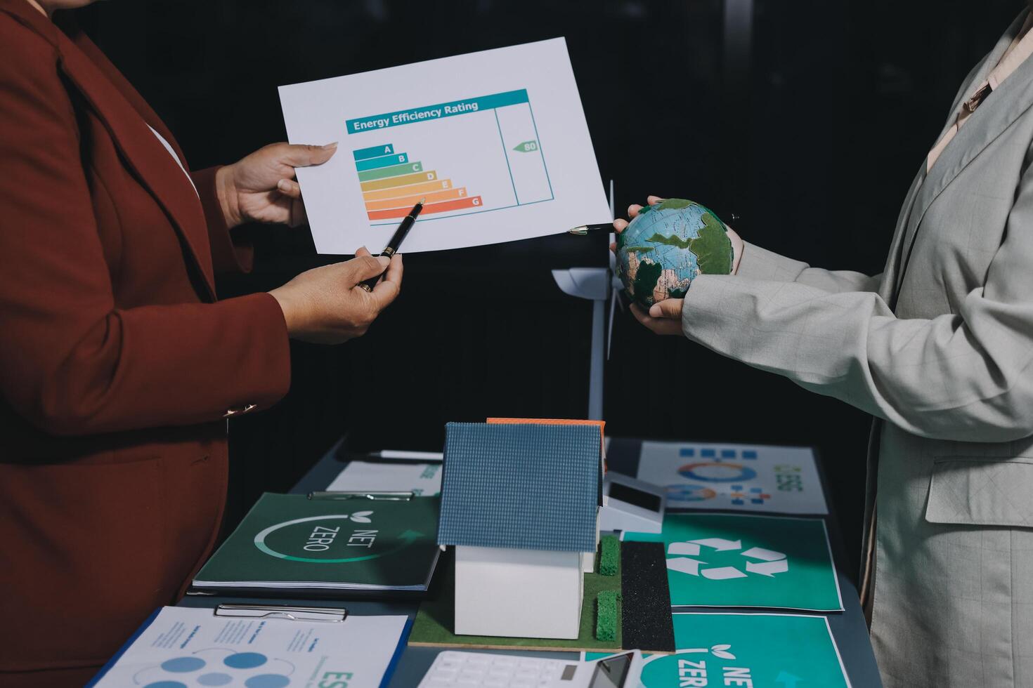 Two business people holding a paper with a graph on it photo