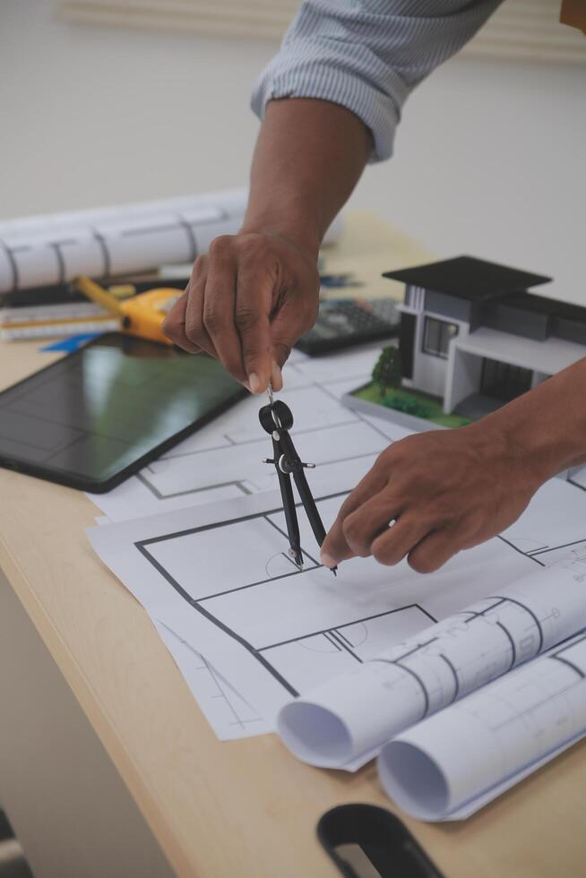 A man is working on a project with a tablet and a pen photo