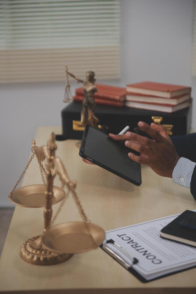 A person in a suit is using a tablet on a desk photo