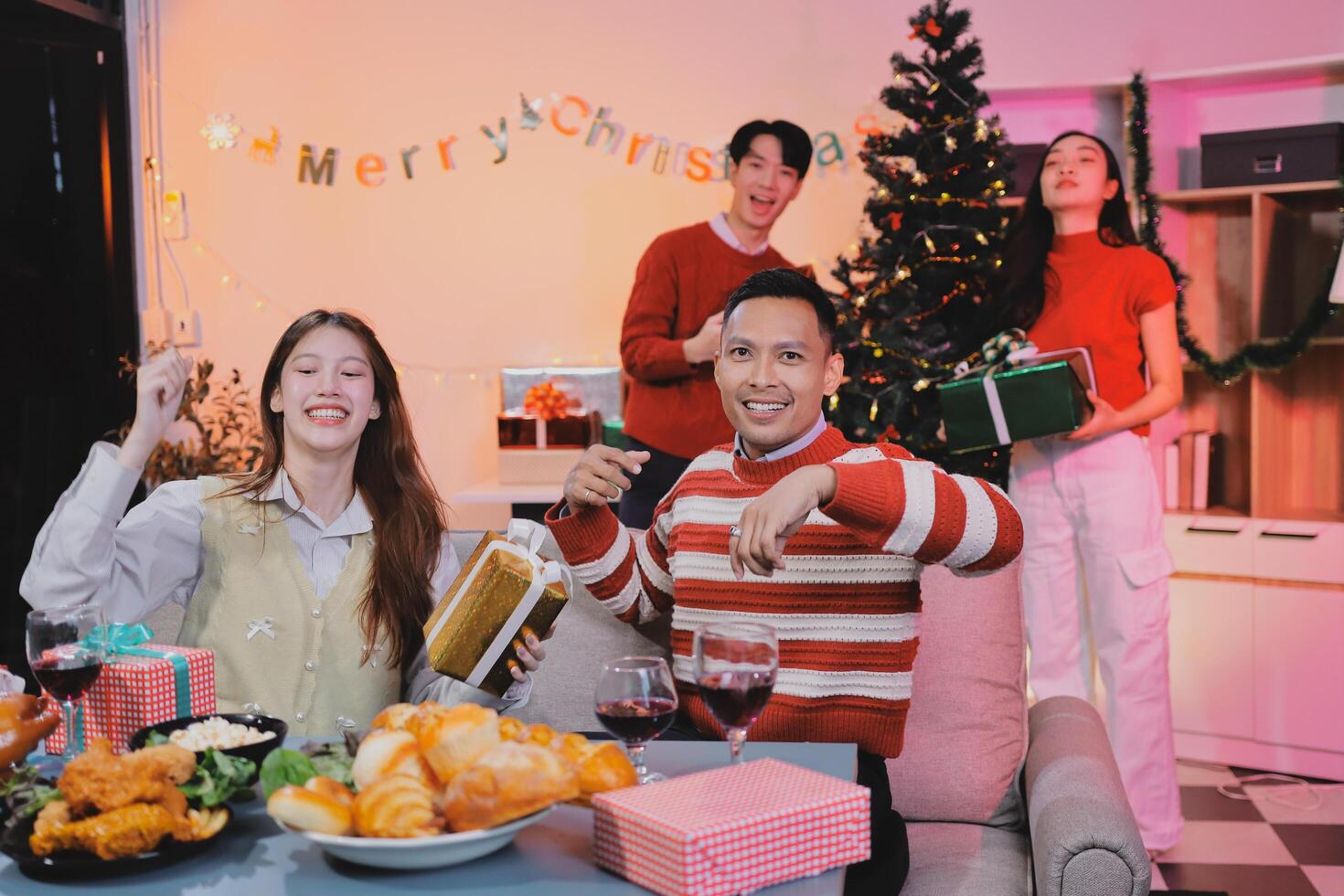 A group of people sitting around a table with christmas decorations photo