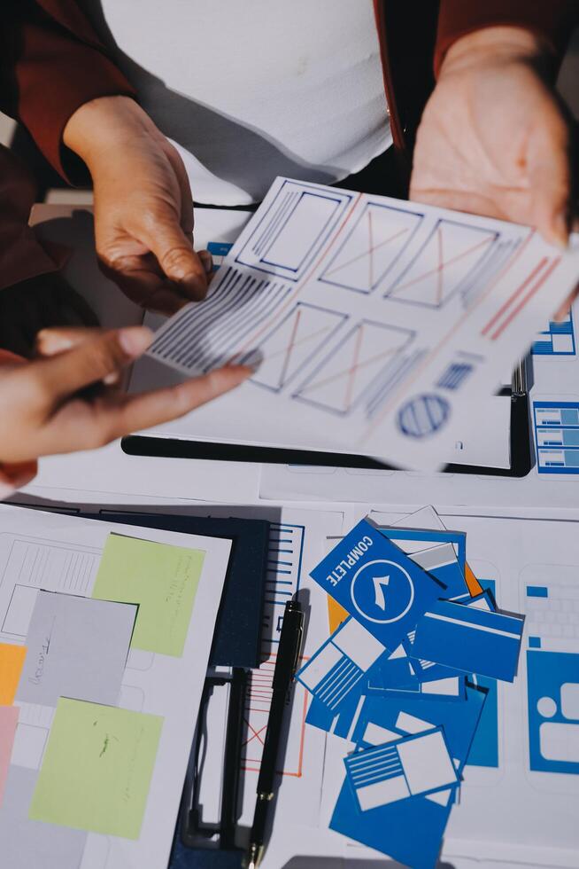 A person is holding a piece of paper with a design on it photo