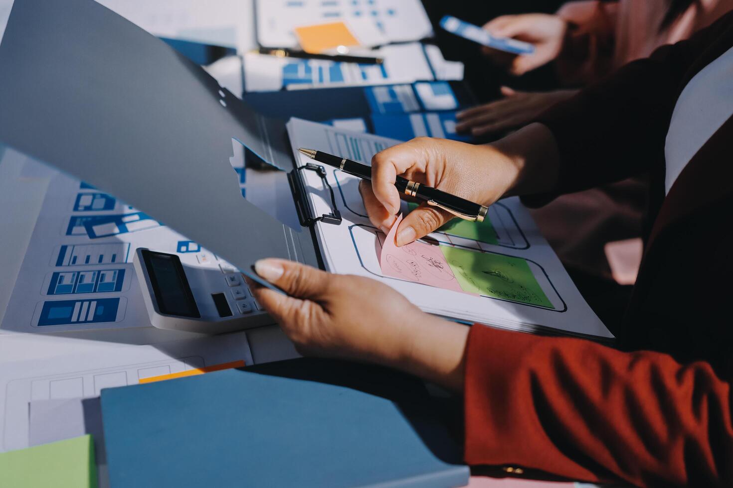 A person is working on a laptop with a pen photo