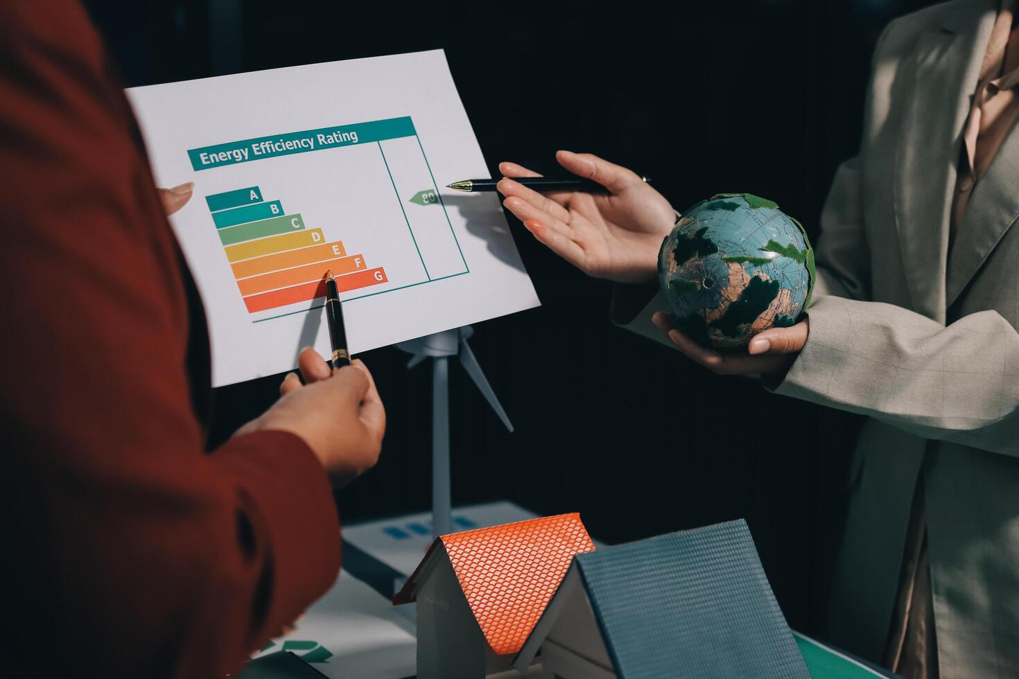 Two people holding a paper with an energy graph on it photo