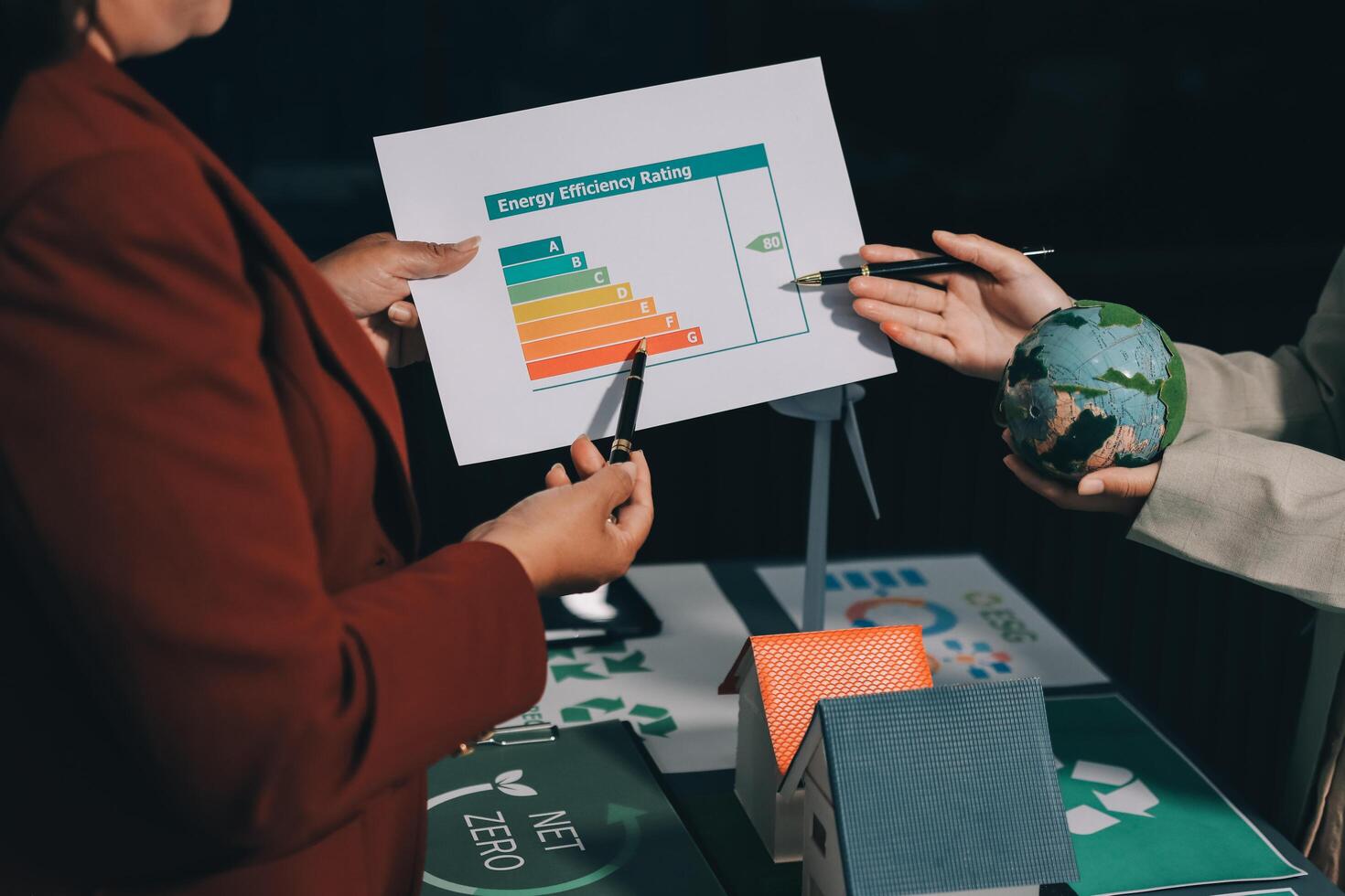 Two business people holding a paper with a graph on it photo