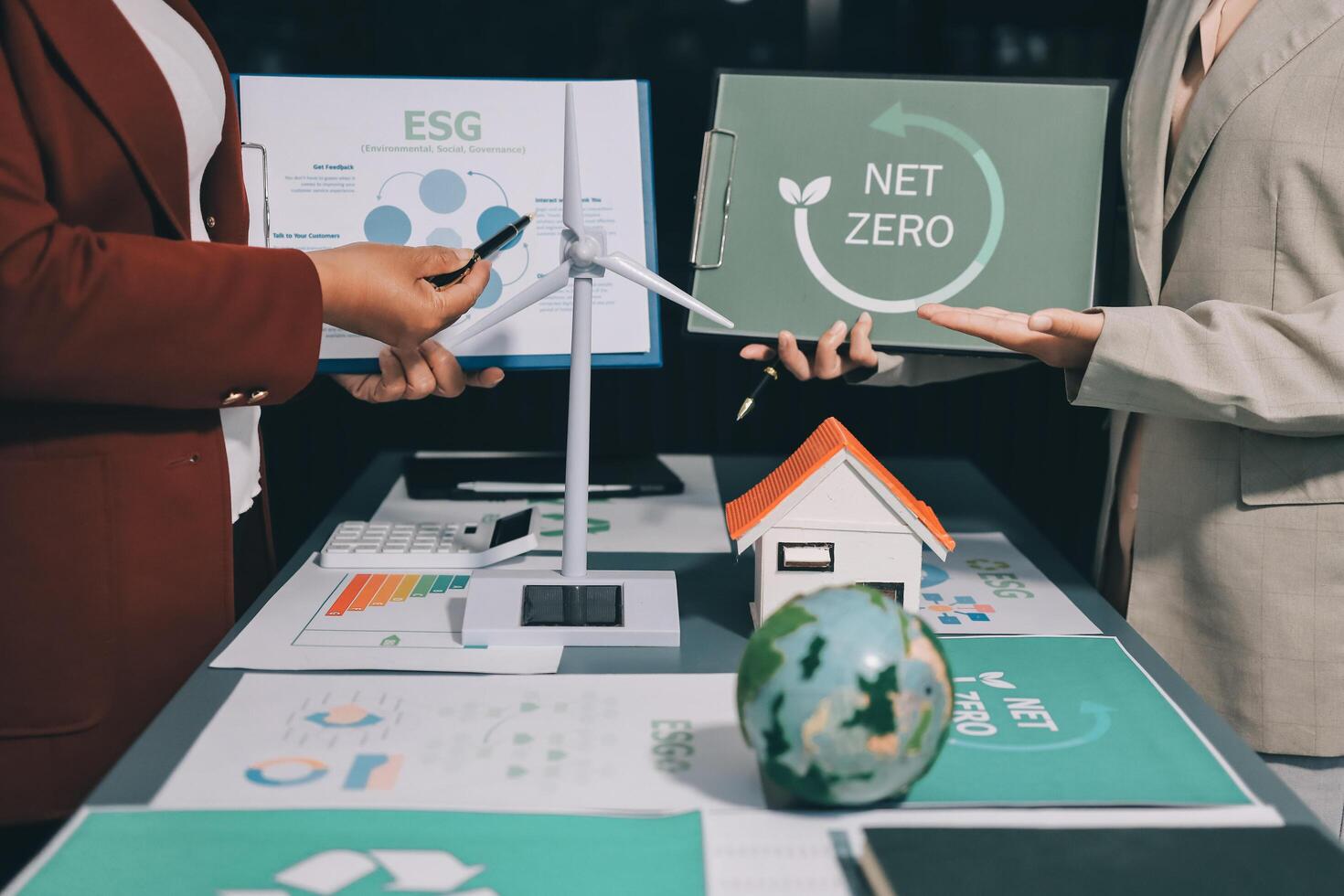 Two business people holding up a net zero sign photo