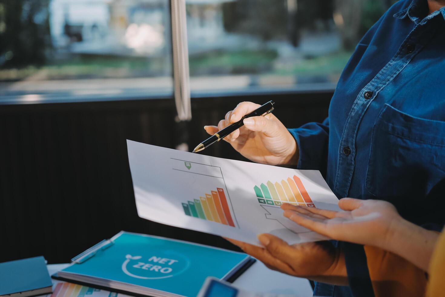 A man and woman are holding a piece of paper with graphs on it photo