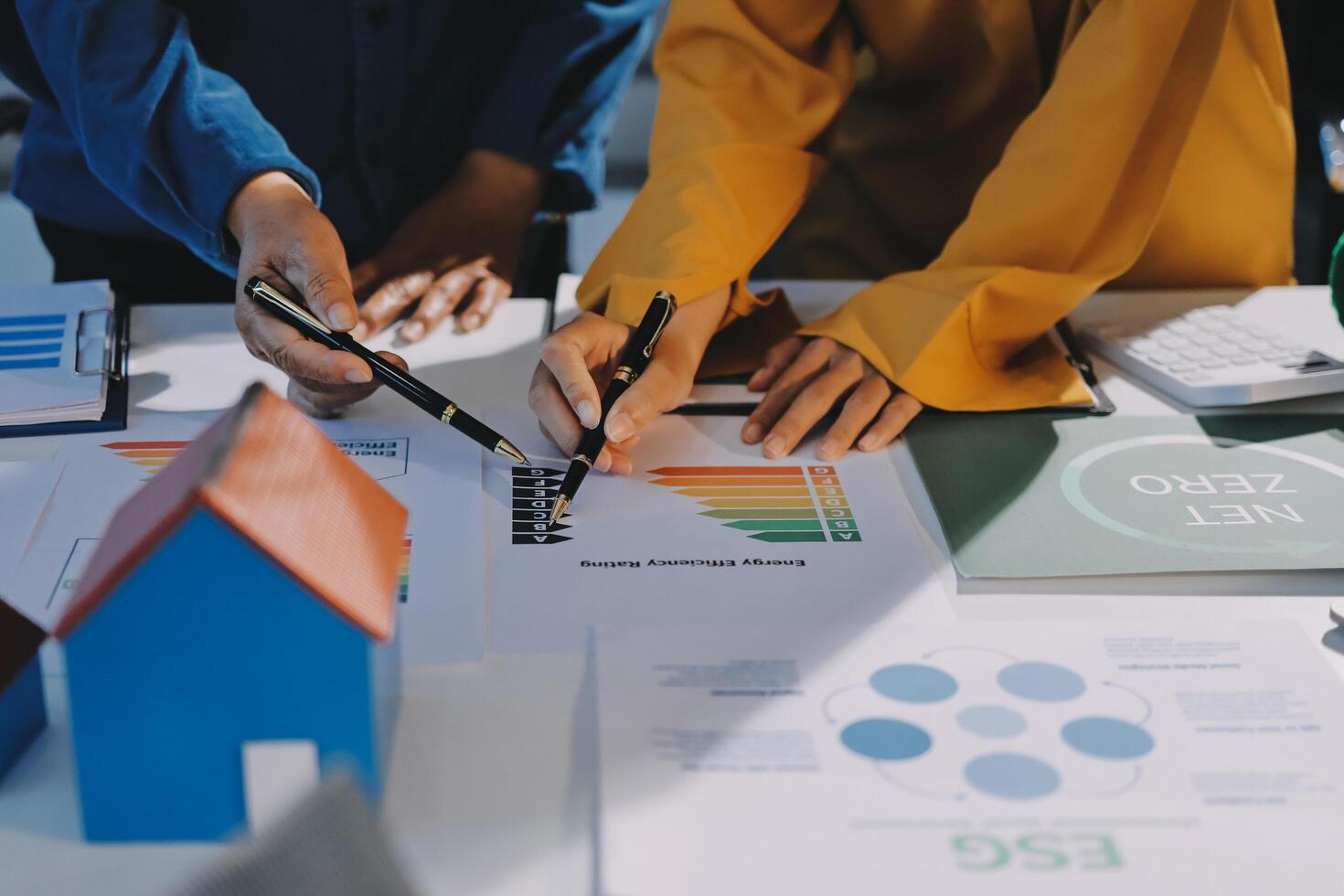 Business people working on a project with graphs and papers photo