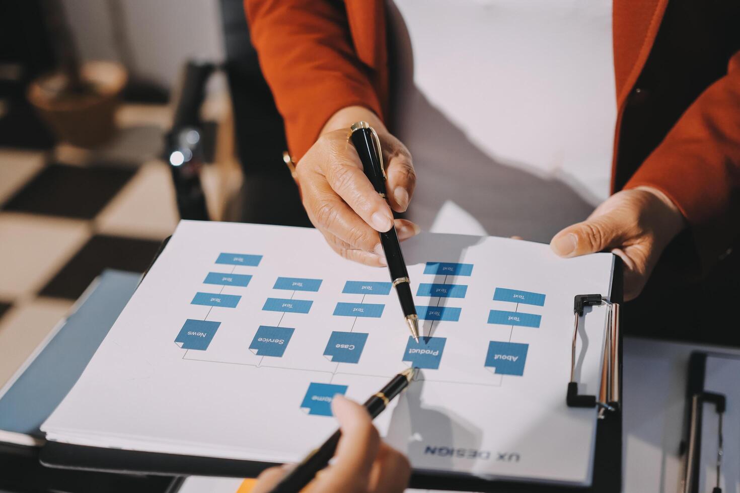 A person holding a pen and paper with a diagram on it photo