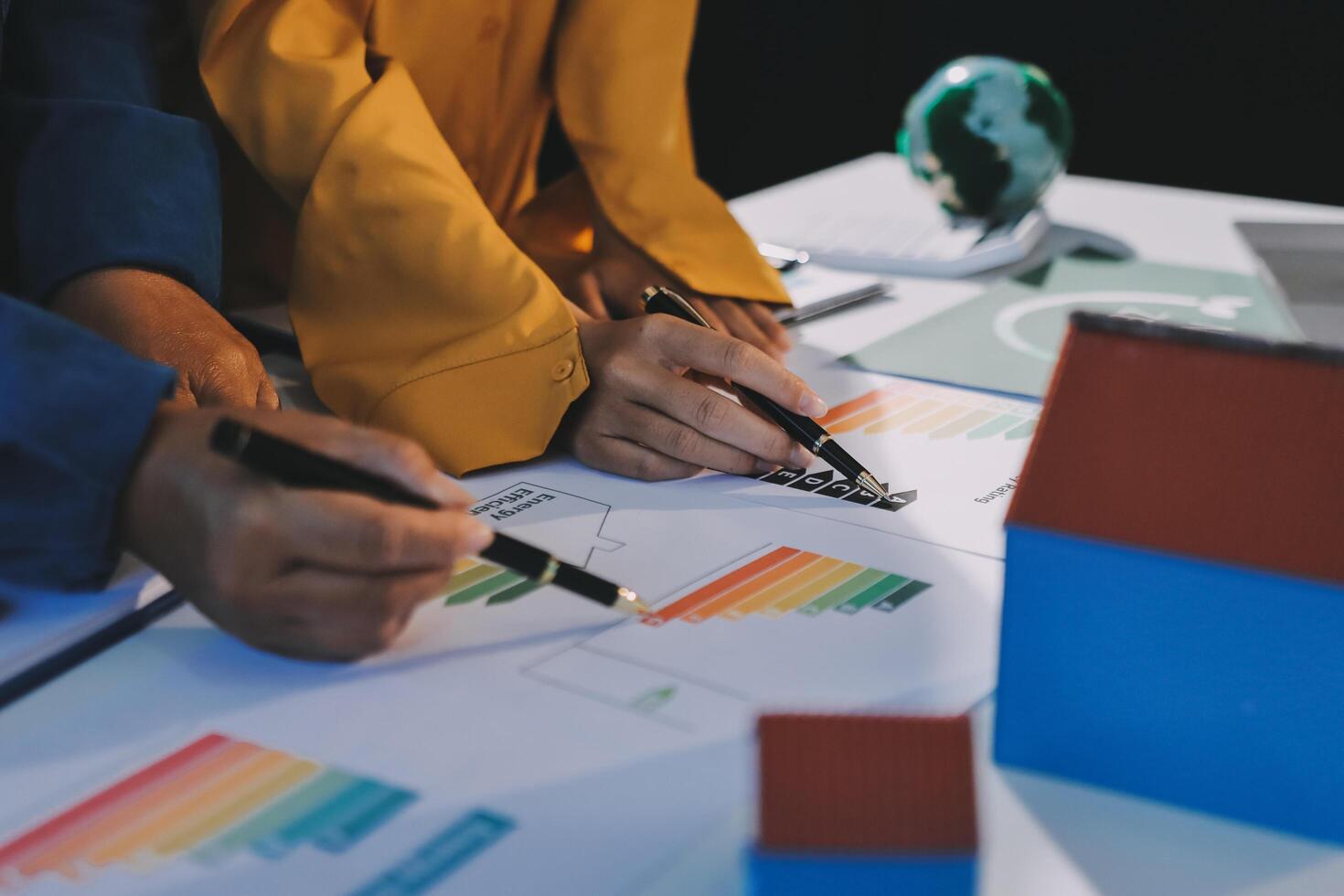 Business people working on a project with graphs and papers photo