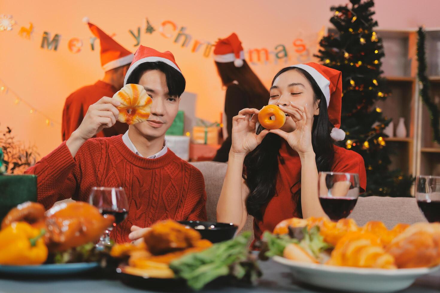 A couple in christmas clothes eating food photo