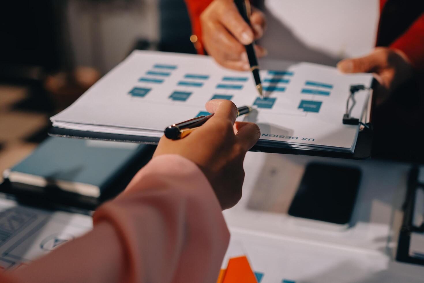 A person is holding a pen and paper while another person is holding a clipboard photo