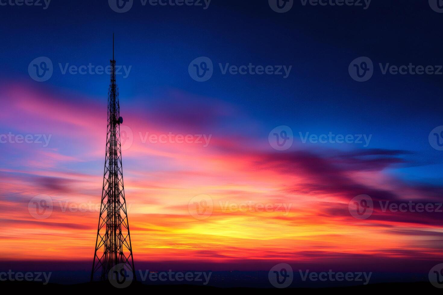 Telecommunication tower standing out against colorful sunset sky photo