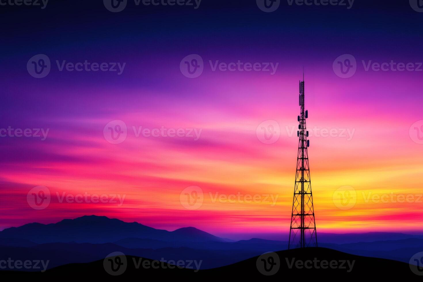 Telecommunication tower standing on a hill at sunset with colorful sky photo