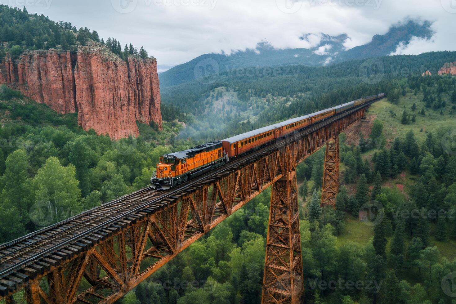Train crossing a bridge in the mountains of Colorado photo