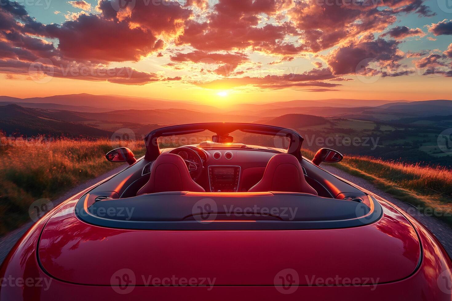 Red convertible sports car enjoying scenic sunset view over mountains photo